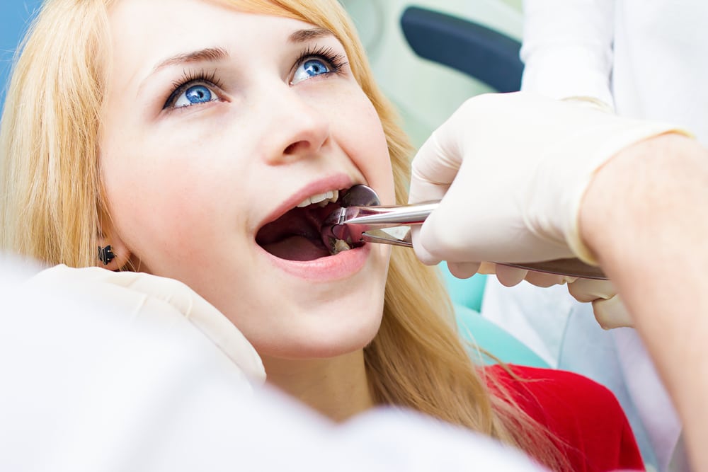 Blonde woman about to get her tooth extracted